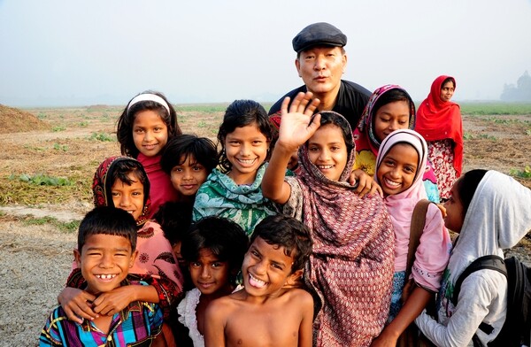Father Lee Jeong-ho poses with a group of children at the first annual