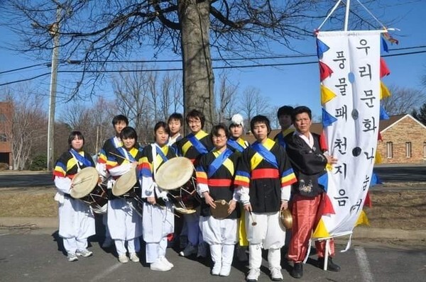 Cho (third from right) with her local pungmul (traditional Korean folk music featuring percussion, dance, and singing) club. (provided by Hyunsook Cho)