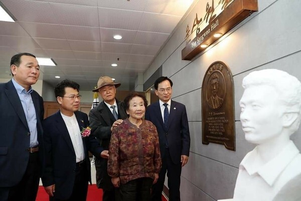 Former Minister of Health and Welfare Lee Tae-bok (third left), chair of the Yoon Sang-won Memorial Project Association, views a bust of democratization activist Yoon Sang-won along with Yoon’s mother (fourth left), Yoon’s brother (far left), and head of Gwangju’s Gwangsan District at the Gwangsan District Office on May 14. (provided by the Gwangsan District Office)