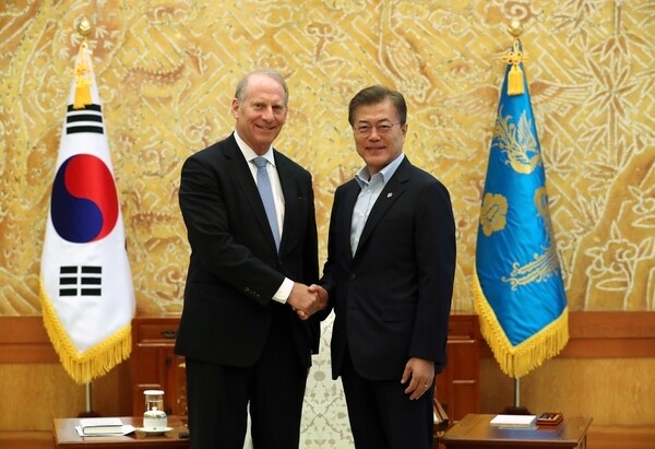 President Moon Jae-in shakes hands with Richard Haass