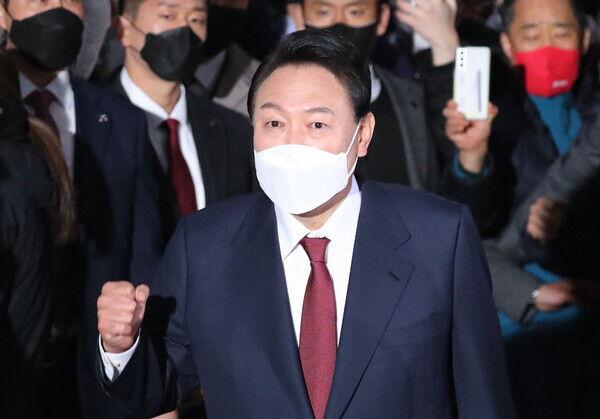 President-elect Yoon Suk-yeol greets supporters outside his home in Seoul’s Seocho District in the early hours of March 10, 2022. (pool photo)