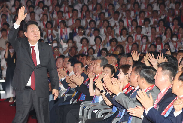 President Yoon Suk-yeol stands and greets the crowd at an event commemorating the 69th founding anniversary of the Korea Freedom Federation held at the Jangchung Gymnasium on June 28. (presidential office pool photo)