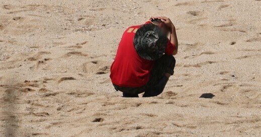 A member of the Marine Corps awaits news of a fellow Marine who was swept away in flood waters while searching for those missing in torrential downpours in North Gyeongsang Province’s Yecheon County on July 19. (Yonhap)