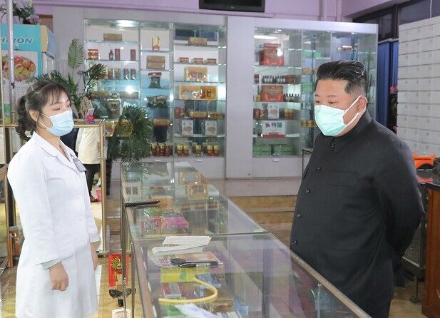 This photo, released by state-run media, shows North Korean leader Kim Jong-un visiting a pharmacy in Pyongyang to “acquaint himself with the supply of medicines” on May 15. (KCNA/Yonhap News)