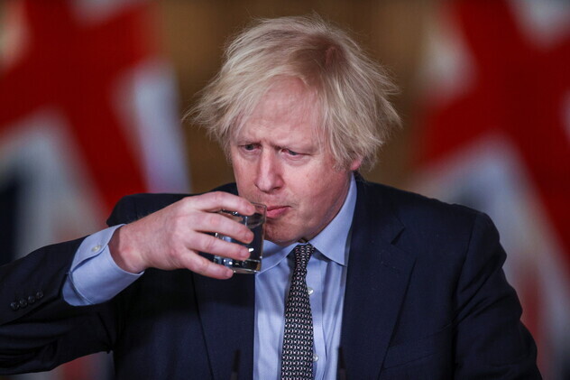 UK Prime Minister Boris Johnson drinks water at a Downing Street press briefing on Tuesday in London, United Kingdom. (Reuters/Yonhap News)