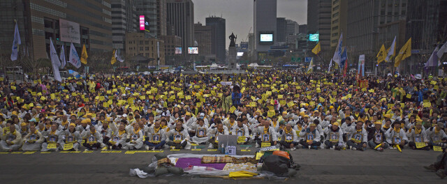 Families of victims of the Sewol ferry sinking pass a park while marching from the government memorial altar in Ansan