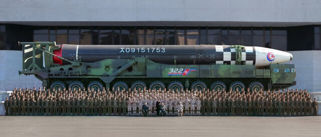 North Korean leader Kim Jong-un sits for a photo with “contributors to successful test-fire of new-type ICBM Hwasongpho-17” on Nov. 18. (Yonhap)