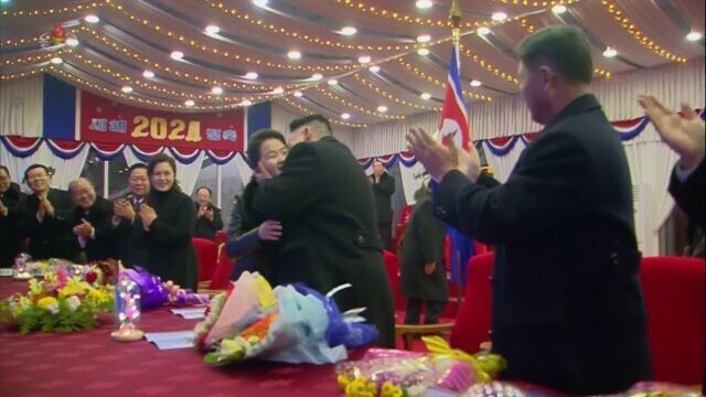 Photo ⑦: While attending a New Year’s event on Jan. 1 at Rungrado 1st of May Stadium in Pyongyang, Kim Jong-un was caught on camera giving his daughter a kiss on the cheek. (still from KCNA/Yonhap)