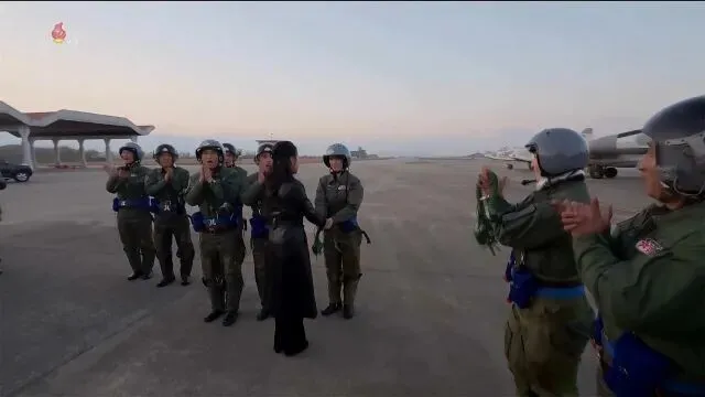 On Nov. 28, 2025, Kim Ju-ae was shown shaking hands with fighter pilots during the ceremony for the 80th anniversary of the air force’s establishment. (still from Korea Central TV/Yonhap)