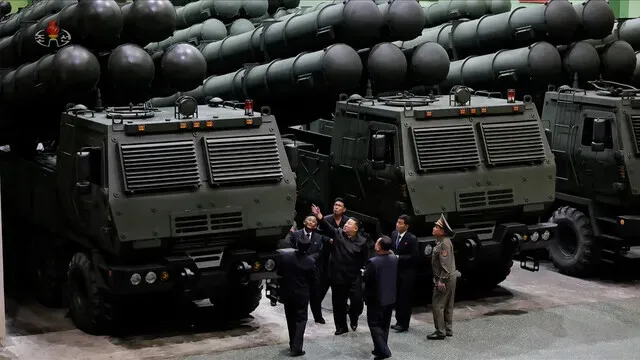 North Korean state media released this photo of leader Kim Jong-un inspecting newly produced 600 mm super-large multiple rocket launchers at a munition factory on Sept. 16-18. (Yonhap)
