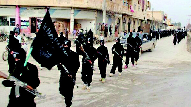 IS fighters march in Raqqa
