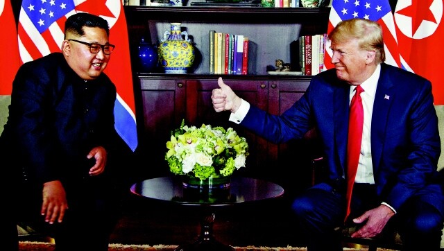 North Korean leader Kim Jong-un (left) and US President Donald Trump engage in some small talk before commencing the Singapore summit on June 12. (Yonhap News)