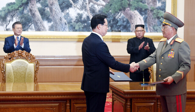 On Sept. 19, 2018, South Korean Defense Minister Song Young-moo (front left) and North Korean Defense Minister No Kwang-chol (front right) shake hands after signing the Agreement on the Implementation of the Historic Panmunjom Declaration in the Military Domain, known also as the Comprehensive Military Agreement or Sept. 18 military agreement, as the respective leaders of the South and North look on. (Pyongyang press pool)