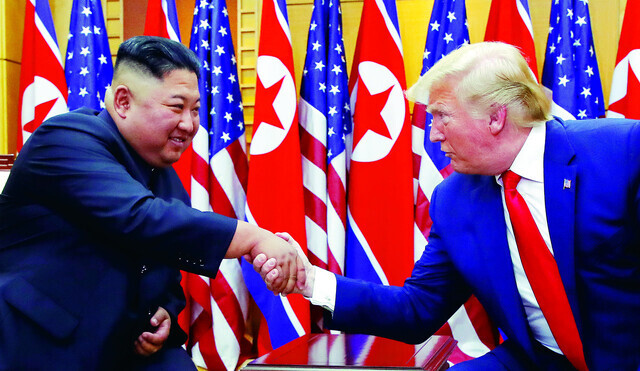 North Korean leader Kim Jong-un shakes hands with then-President Donald Trump of the US on June 30, 2019, ahead of a summit at Panmunjom in Korea. (Yonhap)