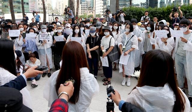 Participants prepare a commemorative march for the victim of a recent murder in Gangnam