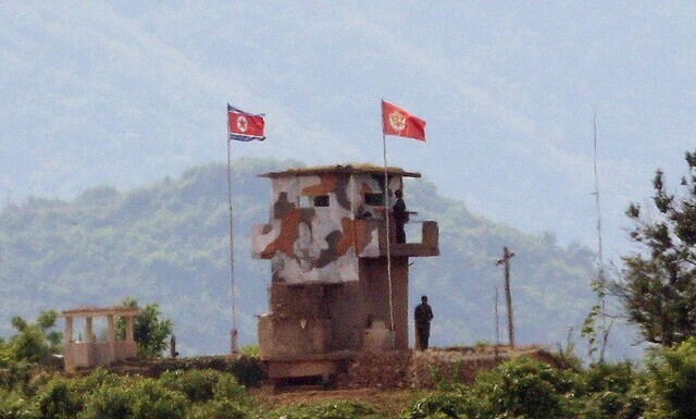 North Korean soldiers patrol a guard post in the DMZ in Kaepung County, North Hwanghae Province, on June 17. (Kim Bong-gyu, staff photographer)