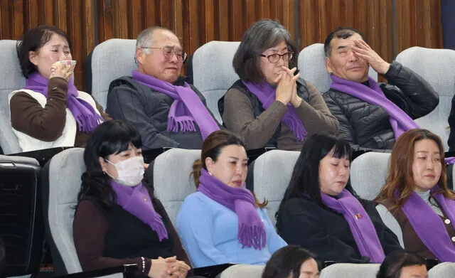 People who lost family members in the crowd crush on Oct. 29, 2022, in Seoul’s Itaewon neighborhood sit in the National Assembly chamber as lawmakers vote on the passage of a special act that would initiate a probe into the disaster. Before voting, lawmakers with the ruling party walked out of the chamber to boycott the vote. (Yonhap)