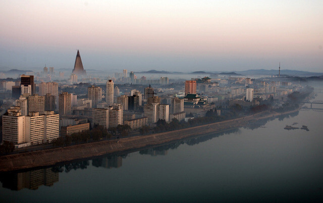 The skyline of Pyongyang along the Taedong River is partially covered in fog on a recent morning.
