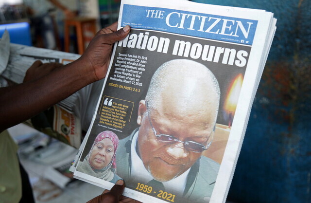 A man holds a newspaper following the death of Tanzania's President John Magufuli in Dar es Salaam, Tanzania on March 18. (Reuters/Yonhap News)