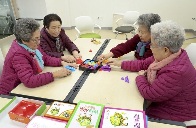 Senior citizens enjoy a game a community residence for the elderly in Seongnam
