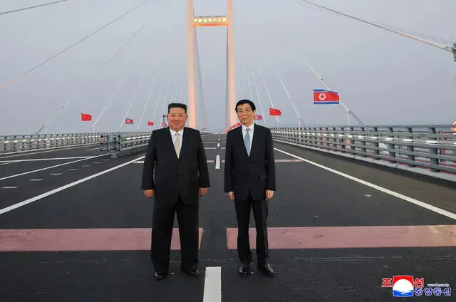 North Korean leader Kim Jong-un and Wang Huning, China’s No. 4 official and chairperson of the National Committee of the Chinese People’s Political Consultative Conference, stand on the newly opened New Yalu River Bridge on Oct. 24, 2026. (KCNA/Yonhap)