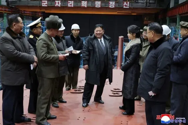 North Korea’s party-run Rodong Sinmun published on Dec. 25, 2025, photos of leader Kim Jong-un receiving a report on the progress of the building of an 8,700-tonnage nuclear-powered strategic guided missile submarine, though the date and location of the visit were not made public. (KCNA/Yonhap)