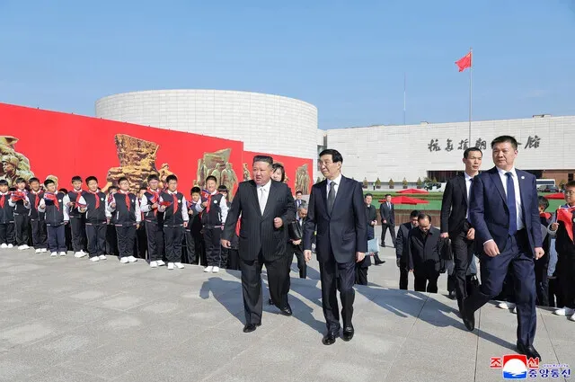 North Korean leader Kim Jong-un walks with Wang Huning, China’s No. 4 official and chairperson of the National Committee of the Chinese People’s Political Consultative Conference, on the grounds of the Memorial Hall of the War to Resist US Aggression and Aid Korea in Dandong, China, on Oct. 24, 2026. (KCNA/Yonhap)