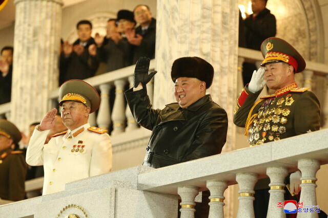 In this photo released by North Korea’s state-run Korean Central News Agency, North Korean leader Kim Jong-un waves his hand during a military parade celebrating the 8th Workers’ Party of Korea Congress in Pyongyang on Jan. 14. (Yonhap News)