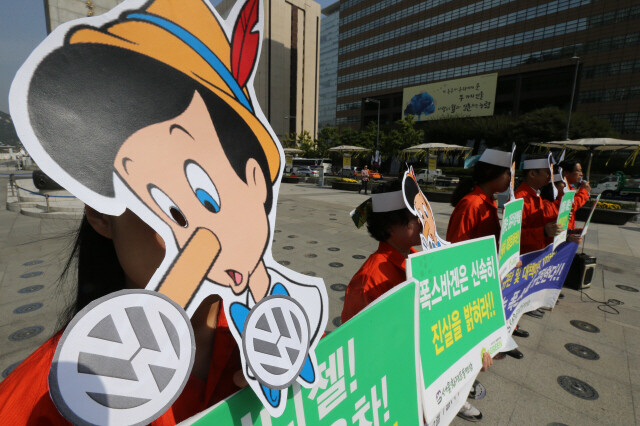 Members of Korean Federation of Environmental Movement hold a press conference with a Pinocchio in Seoul’s Gwanghwamun Square