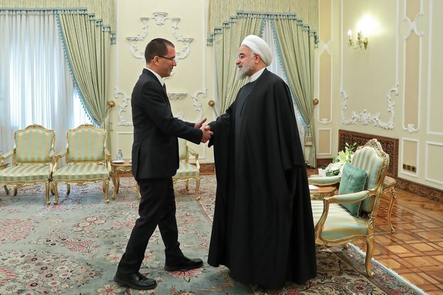 Iranian President Hassan Rouhani shakes hands with Venezuelan Foreign Minister Jorge Arreaza during the latter’s visit to Tehran on Jan. 21. (AFP)
