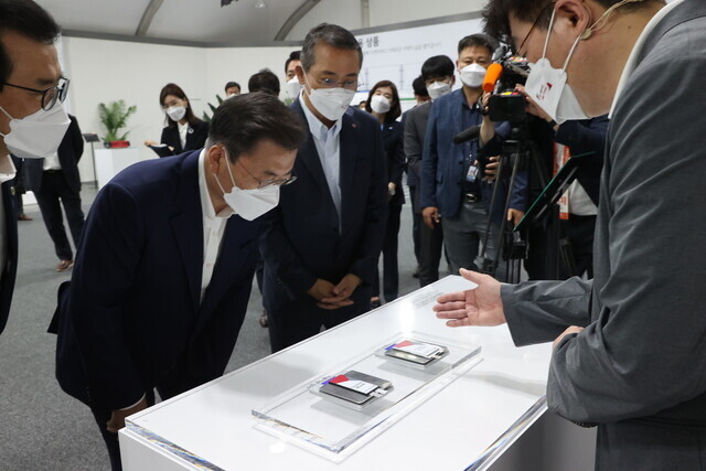 South Korea President Moon Jae-in looks at displays at an LG Energy Solution factory in Ochang, North Chungcheong Province, on Thursday.