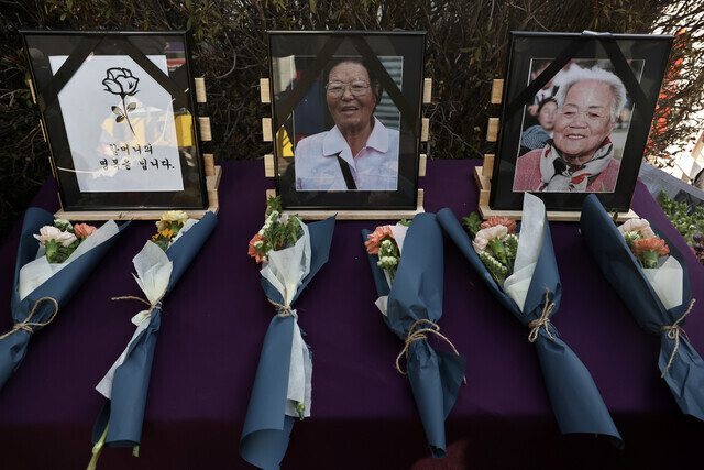 An altar holds flowers and photos of Lee Ok-seon (right) and Kim Yang-ju, two victims of Japan’s military-backed system of sexual slavery, at a memorial ceremony held during a Wednesday Demonstration outside the former Japanese Embassy in Seoul on Dec. 28, 2022. (Yonhap)