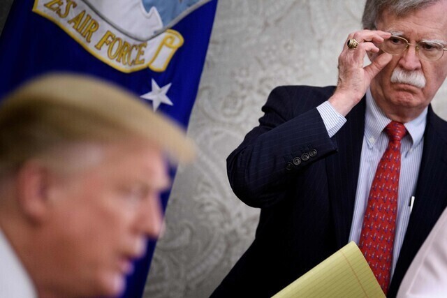 White House national security advisor John Bolton listens to President Donald Trump speak at a press conference at the White House on May 13, 2019. (AFP/Yonhap)