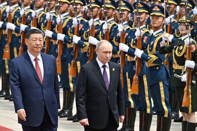 President Xi Jinping of China and Russian President Vladimir Putin walk past the Chinese soldiers in Beijing on May 16, 2024. (courtesy of the Kremlin)