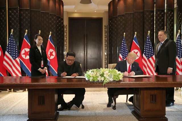 President Donald Trump and North Korean leader Kim Jong-un sign a joint statement during the North Korea-US summit at Singapore’s Capella hotel on June 12. (Reuters/Yonhap News)