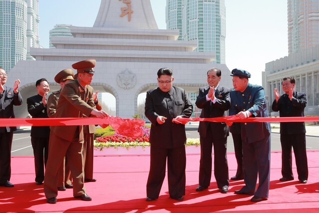 North Korean leader Kim Jong-un cuts the ribbon for an opening ceremony for Ryomyong Street on Apr. 13