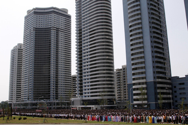 Pyongyang residents gather for the opening ceremony of a new apartment complex on Changjon Street in 2012
