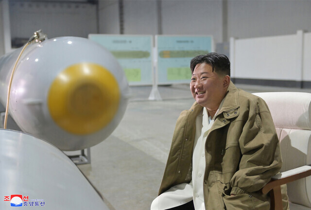 North Korean leader Kim Jong-un sits next to nuclear torpedoes with what appear to be diagrams of the torpedoes in the background, in this photo released by North Korean state media on March 24. (KCNA/Yonhap)