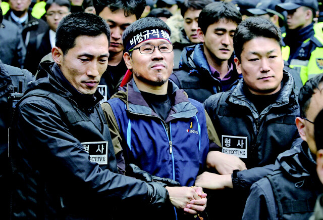 Korean Confederation of Trade Unions president Han Sang-gyun is arrested by police after leaving Jogye Temple in Seoul