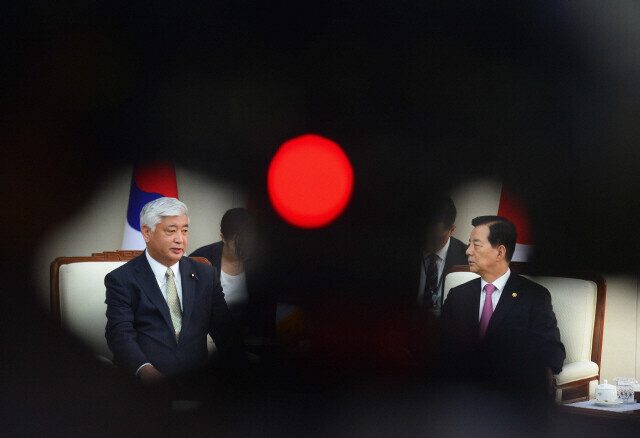 A meeting between then Japanese Defense Minister Gen Nakatani (left) and then South Korean Defense Minister Han Min-koo in October 2015. (Yonhap News)