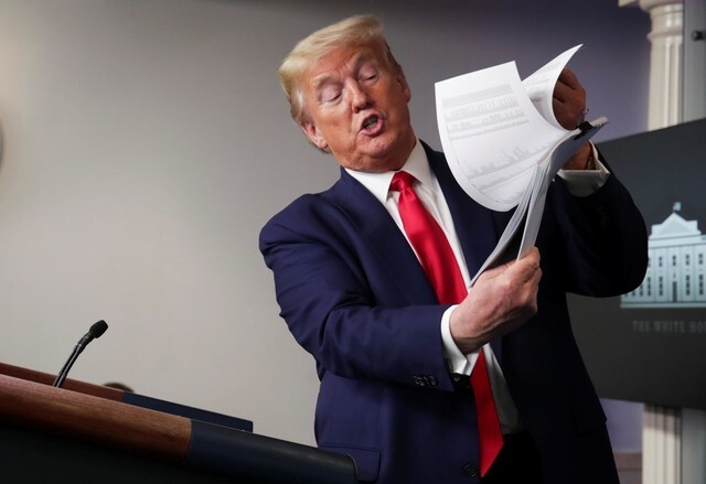 \US President Donald Trump holds up a list of COVID-19 testing sites within the US during a White House novel coronavirus task force briefing on Apr. 20. (Yonhap News)