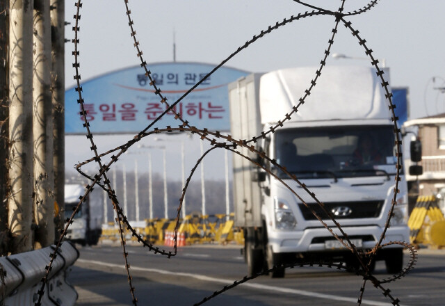 Vehicles leaving the Kaesong Industrial Complex drive across Unification Bridge in Paju