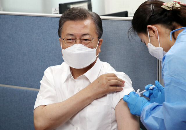 South Korean President Moon Jae-in receives AstraZeneca’s COVID-19 vaccine at a public health center in Seoul on Tuesday. (Yonhap News)