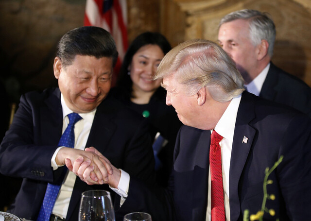 Chinese President Xi Jinping and US President Donald Trump shake hands during their summit at the Mar-a-lago Resort in Florida