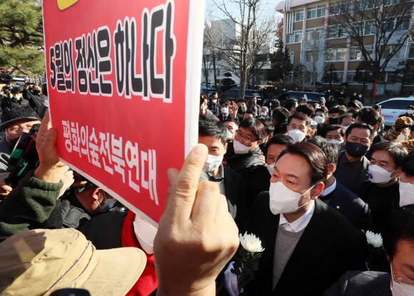 윤석열 국민의힘 대선 후보가 22일 오후 전북 전주시 덕진구 전북대학교 이세종 열사 추모비 앞에서 헌화하려다 이를 반대하는 시민단체의 항의를 받고 있다. 연합뉴스