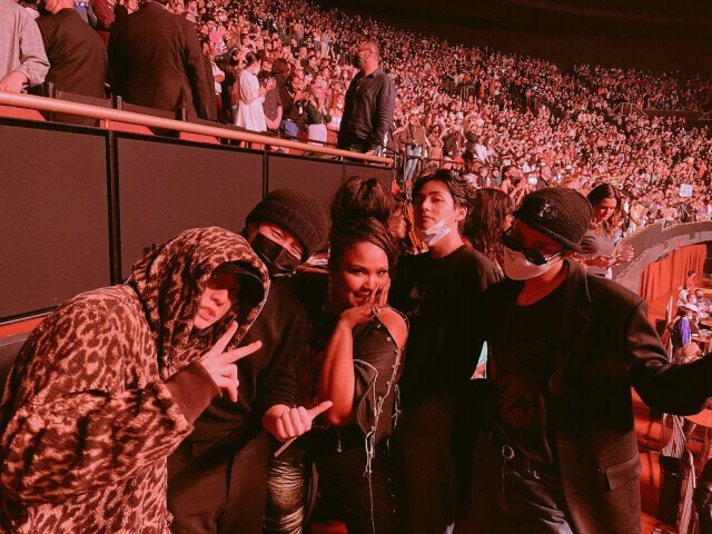 BTS and Lizzo pose for a photo at a Harry Styles concert on Nov. 19 in Los Angeles. (screen capture from BTS’ Twitter account)