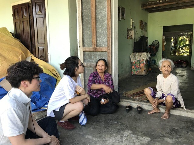 Attorneys with a MINBYUN-Lawyers for a Democratic Society task force visit the home of Nguyen Thi Luong in Phong Nhi Village