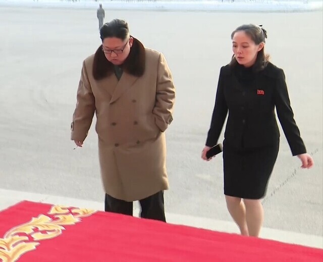 North Korean leader Kim Jong-un and his younger sister Kim Yo-jong, first deputy director of the Central Committee of the Workers’ Party of Korea, head to a New Year’s Eve celebratory performance in Pyongyang on Dec. 30, 2017. (KCTV)