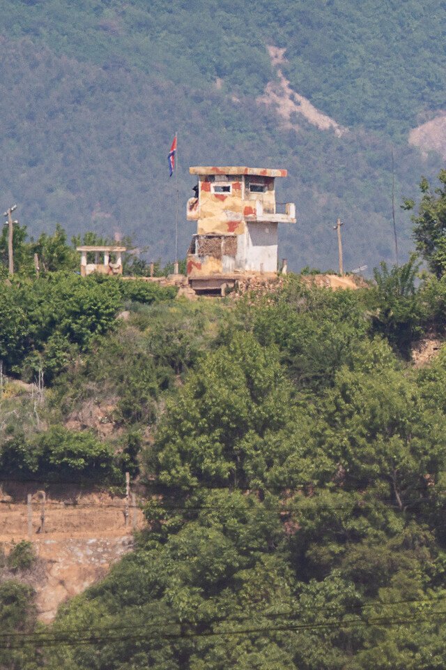 The North Korean flag flies at a guard post on the bank of the Imjin River as seen from Paju, Gyeonggi Province, near the border, on May 10. (Yonhap News)
