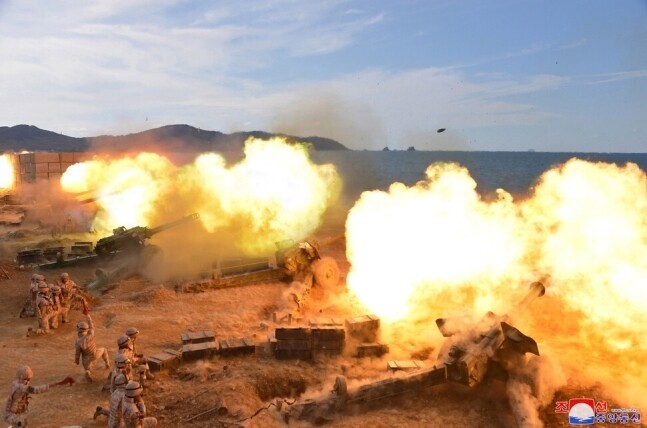 This photo, released by North Korean state media on Oct. 10, 2022, shows artillery exercises carried out by the North’s military for which leader Kim Jong-un gave on-site guidance. (KCNA/Yonhap)